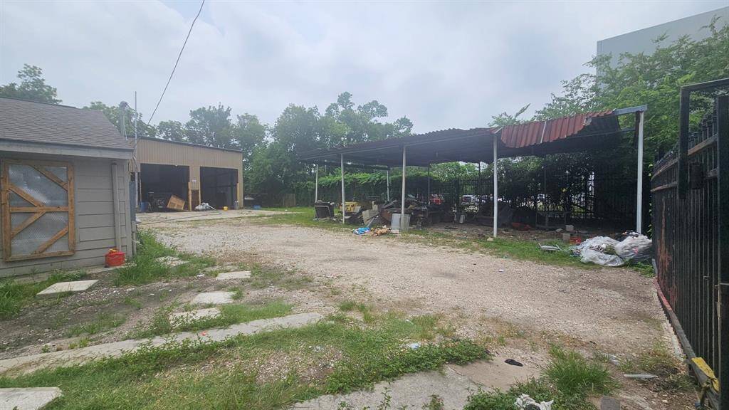 View of carport structure that has dirt floor.