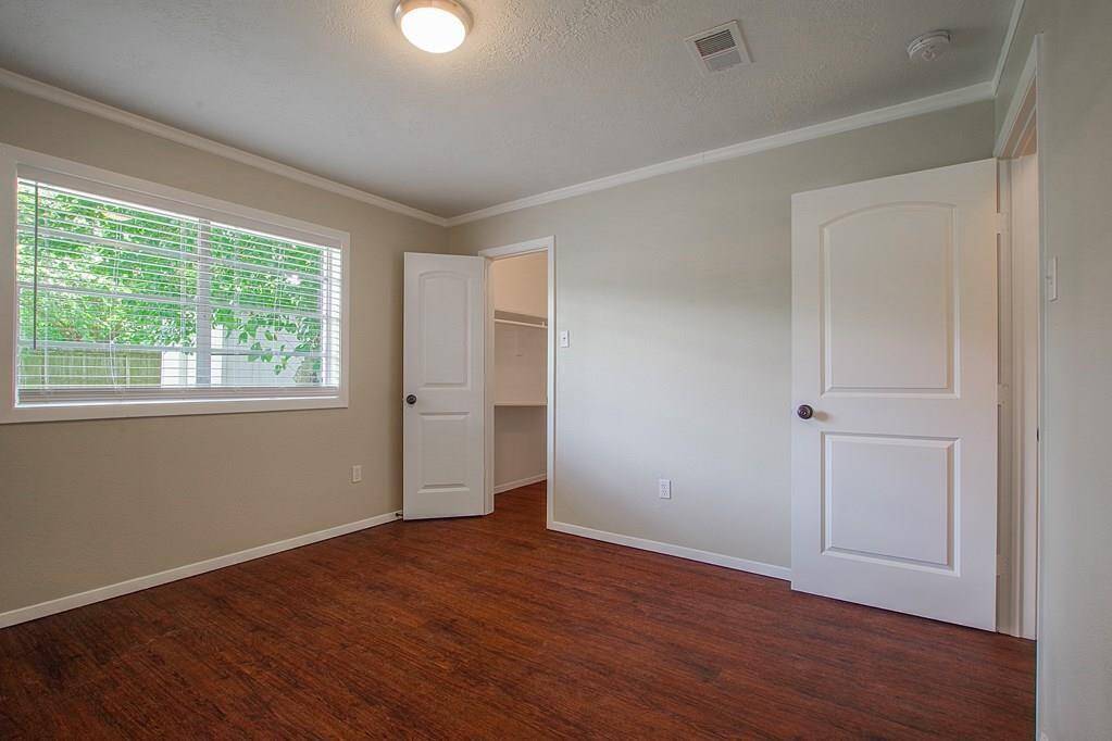 Bedroom with hard wood floors, closetand large window