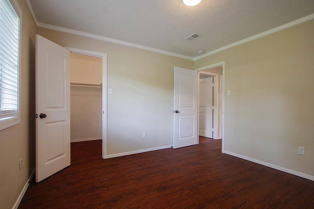 Bedroom with hardwood floors,spacious closet and window.