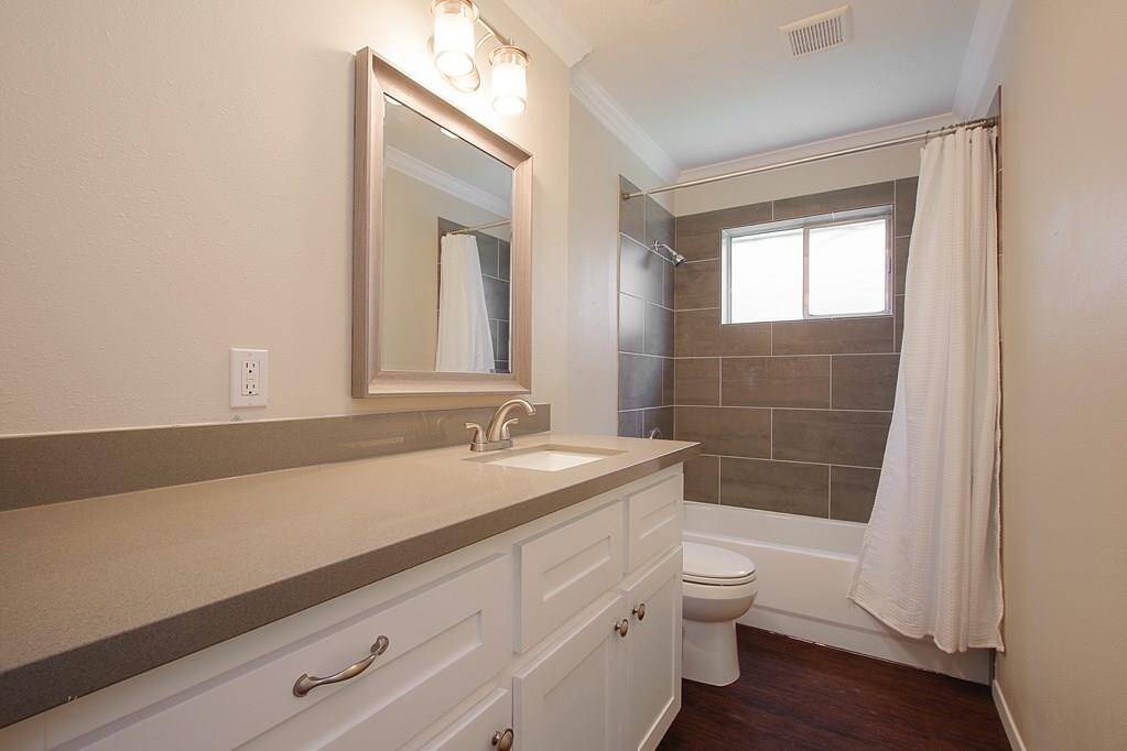 Lots of wonderful counter space in thisbathroom with fresh tile and largewindow