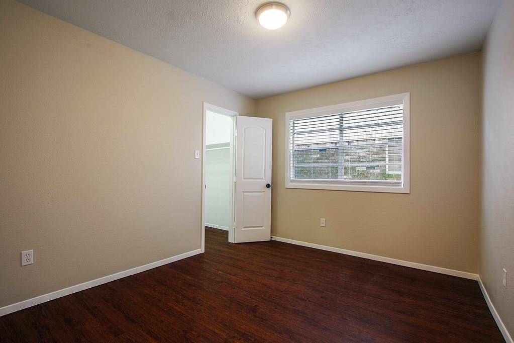 Bedroom with hardwood floors, largewindow