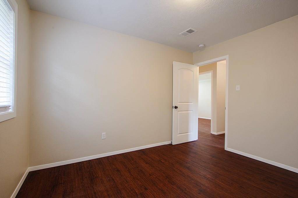 Bedroom with hardwood floors, greatwall space and large window