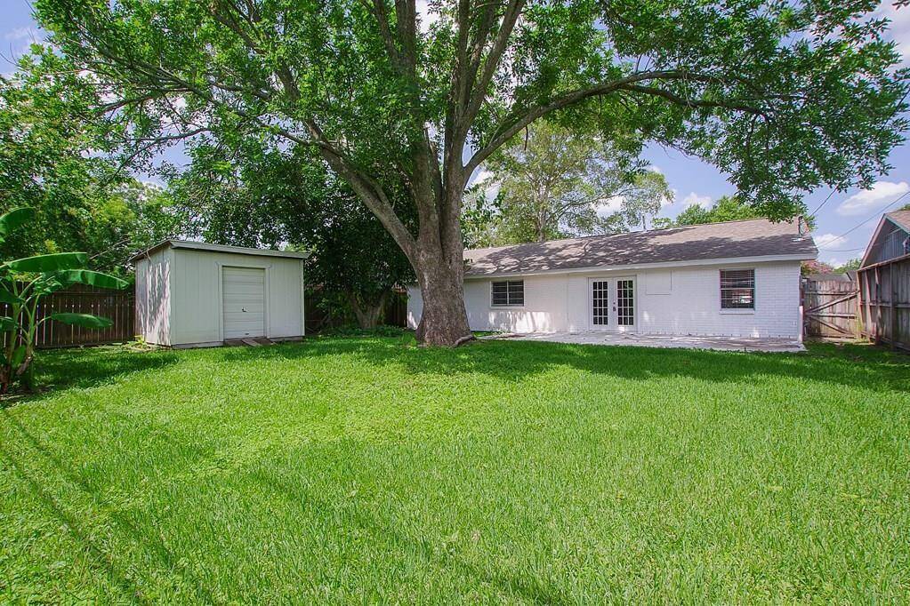 Beautiful back yard with a shed and treewhich provides great shade.