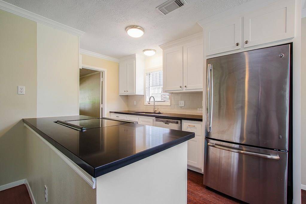 New appliances, cabinetry, and solidstone countertops.