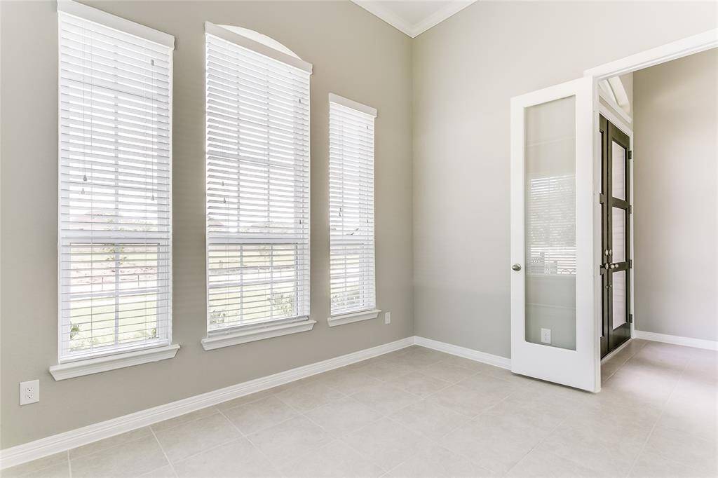 Immediately to the right upon entering, you'll see the Sophisticated Study with Tile Flooring, Wall Of Windows for Natural Lighting and French Door access.