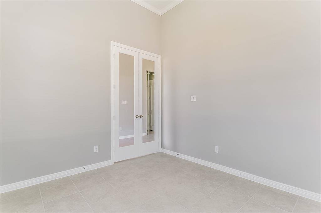 An additional view of the office that features French doors for elegance.