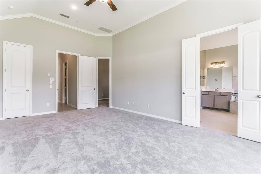 Another view of this Pristine Primary Suite that is accompanied with French Doors, allowing easy access to the Primary Oasis.