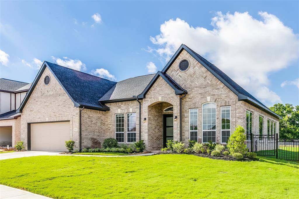 Spectacular Front Elevation, luscious landscaping and LAKEFRONT home!