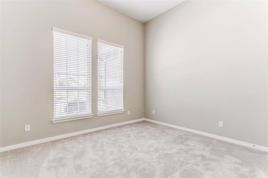 Spacious Secondary Bedroom that offers plush carpeting and natural lighting.