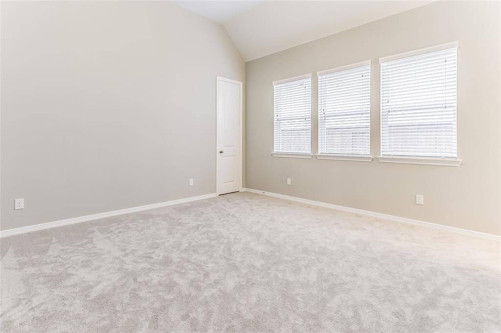 Large Secondary Bedroom with Natural Lighting, High Ceilings, and Plush Carpeting.