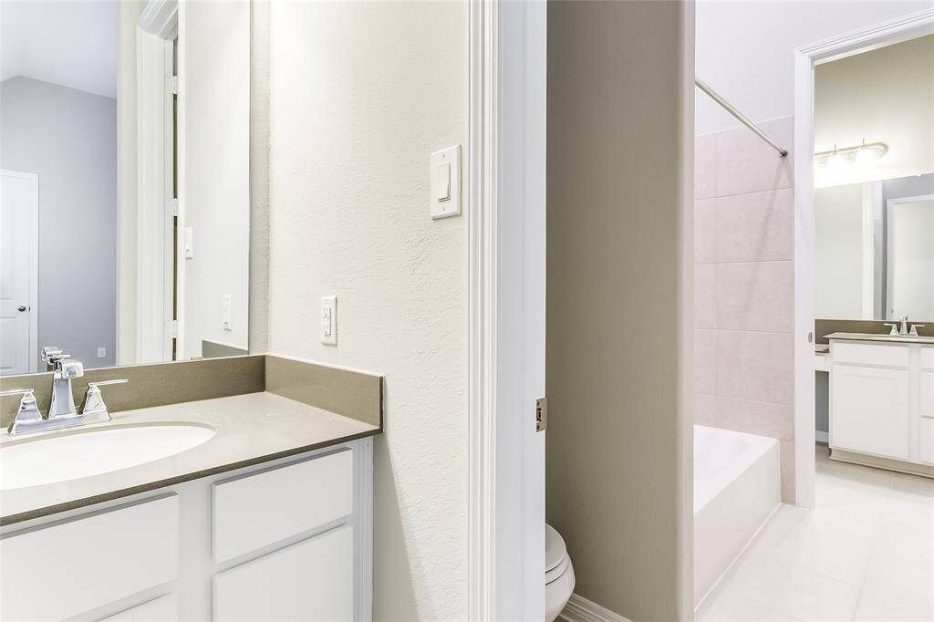 A look into the Striking Jack and Jill Bathroom that offers His & Hers sinks & terrific tile flooring.