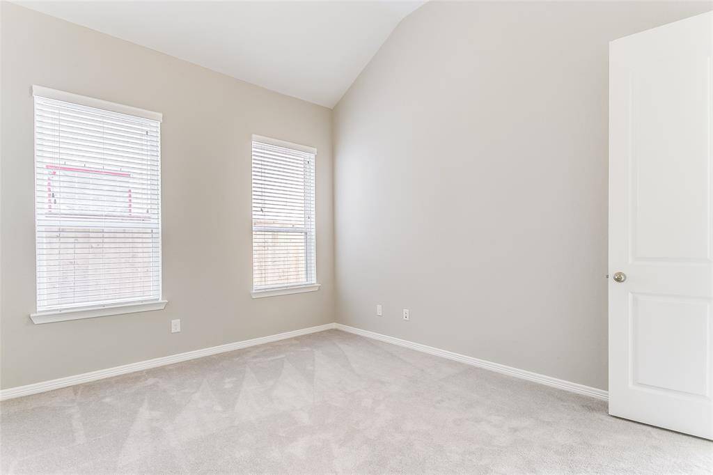 An additional view of the Spacious Secondary Bedroom that features windows for natural lighting and high ceilings!