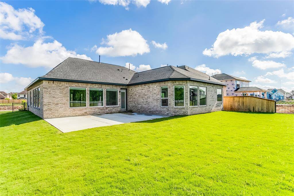 View of the backyard behind the home and abundance of greenspace offered.