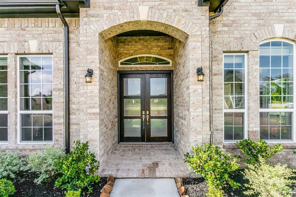 Upon arrival greeted with Large front windows that allow plenty of sunlight into this Elegant Home and covered entry with brick surround.