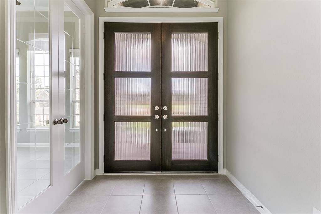 Notice the double front door entrance, adding to that luxurious ambiance of the home that is also accompanied with Terrific Tile Flooring.