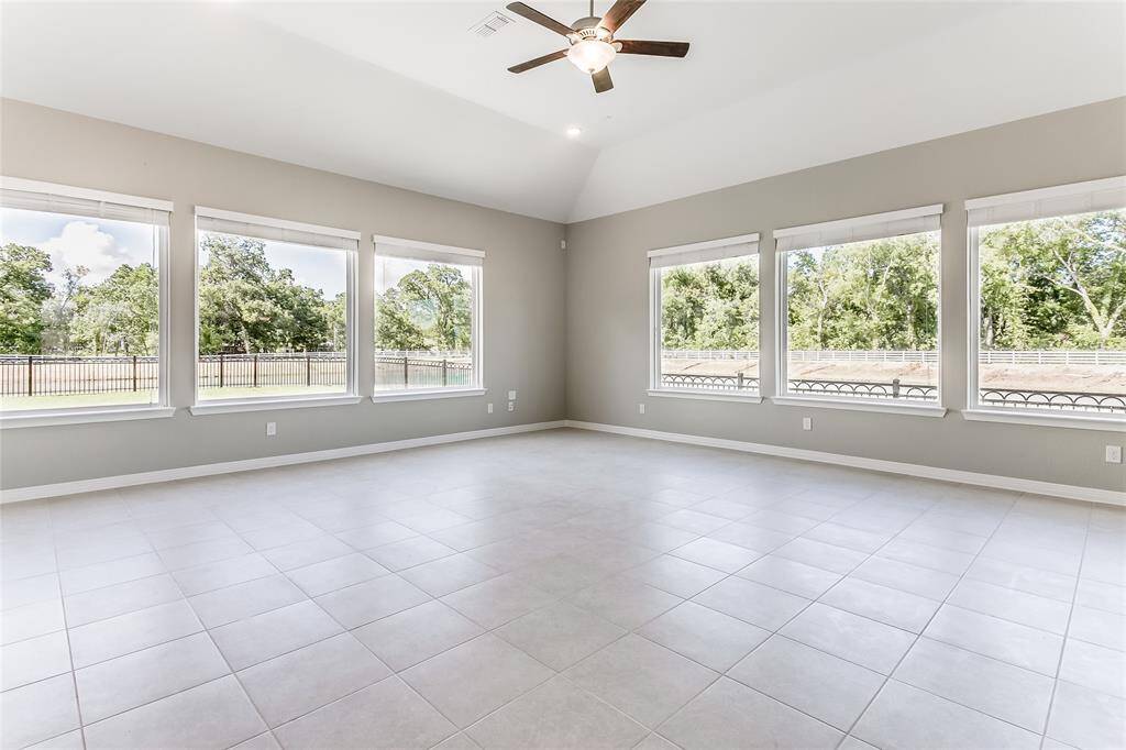 Gorgeous wall of windows offers an abundance of natural sunlight, along with an amazing view of the lake in the back and side yard!