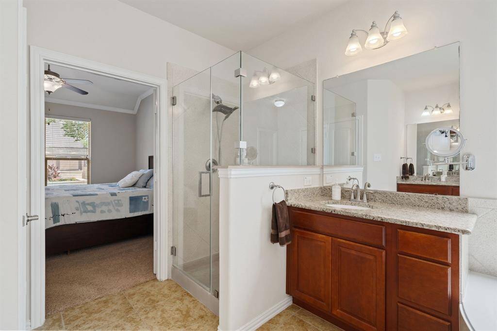 This photo angle confims the master bath has dual sinks, and includes a shot of the glass walk-in shower.