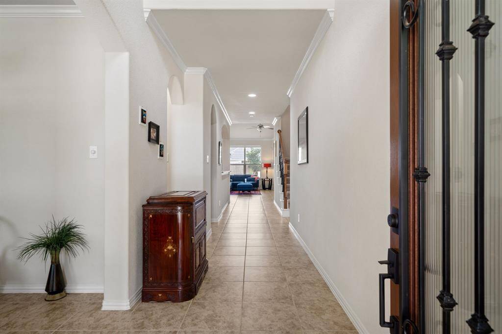 You'll be instantly greeted by beautiful tile floors, a charming stair case, and a view straight back into the backyard!