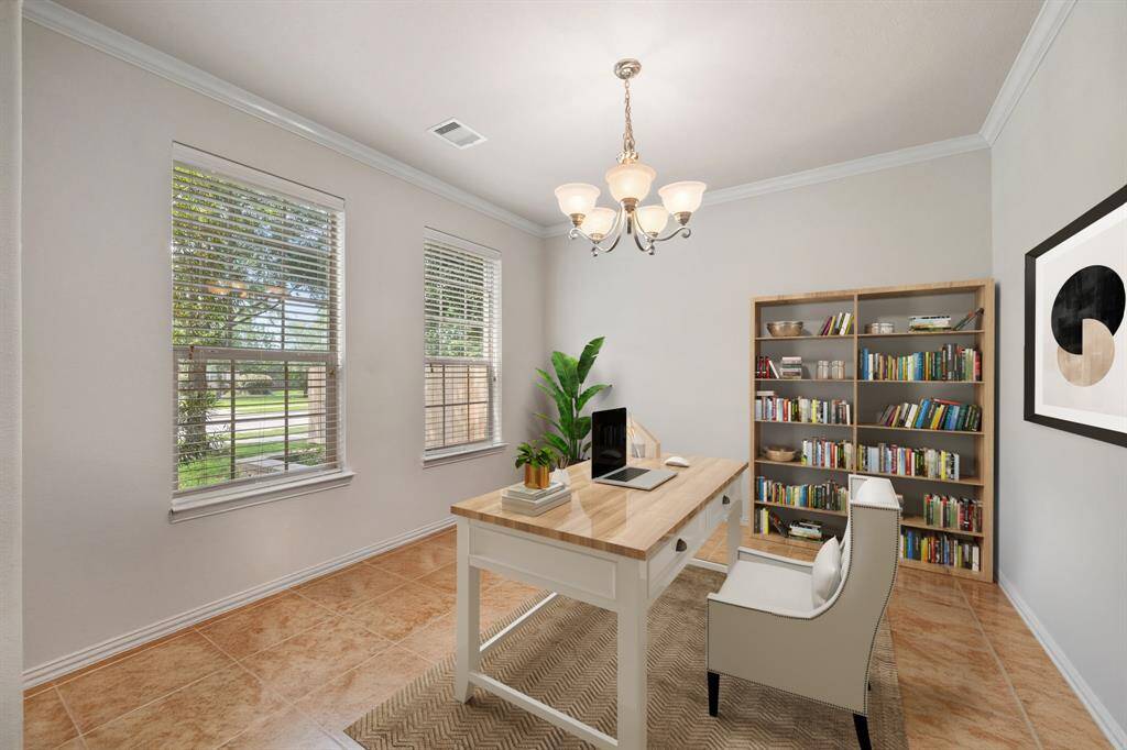 Virtually Staged: This home office is handsome and grand! Featuring tile floors, crown molding details, pendant lighting, and the windows include privacy blinds with views straight into the front yard.