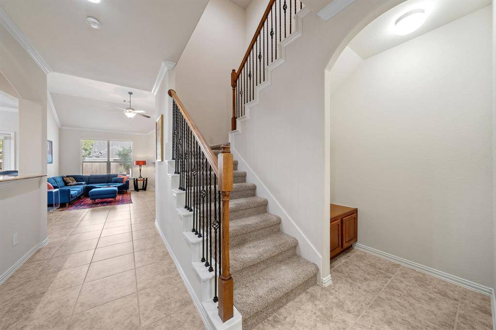 Beautiful staircase with wrought iron and wood detailing.