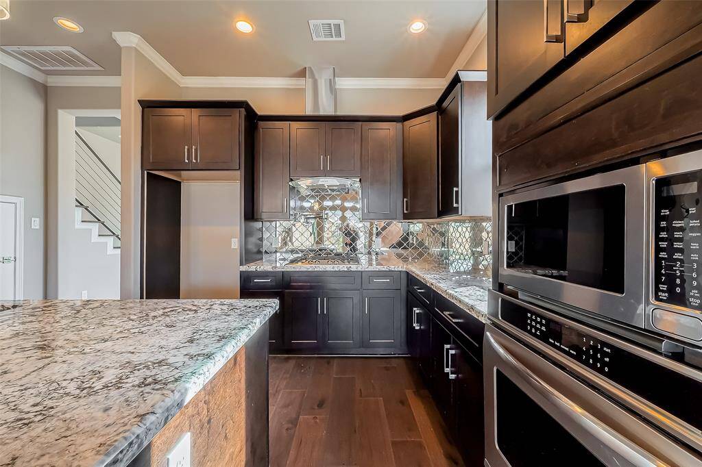 This kitchen comes with a stainless steel microwave and oven.