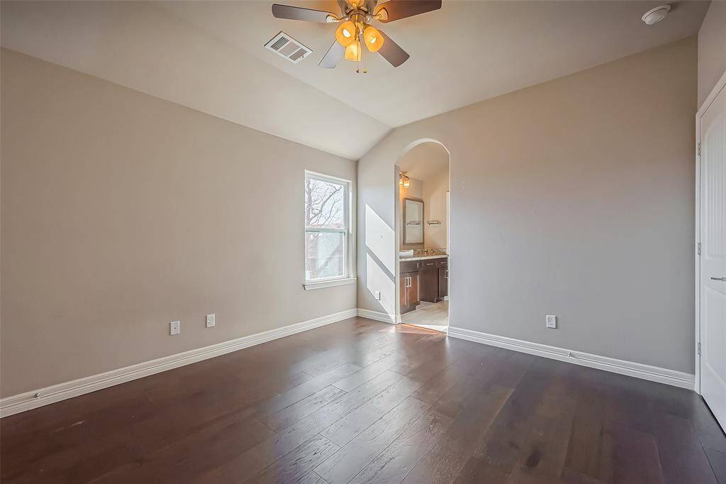 This is the entrance from bedroom #3 into the jack and jill bathroom and dressing area. There is also a ceiling fan with a light kit and large walls for displaying your art.