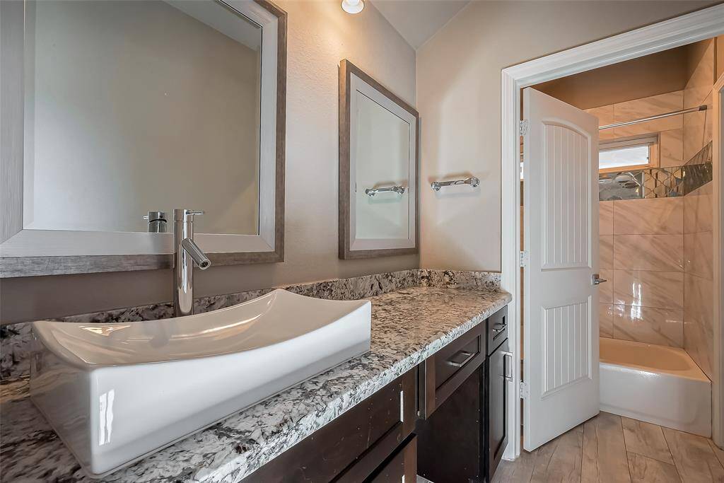 This is the jack and jill bathroom with a modern vessel white sink, double mirrors, make-up cut out to help with dressing each day.