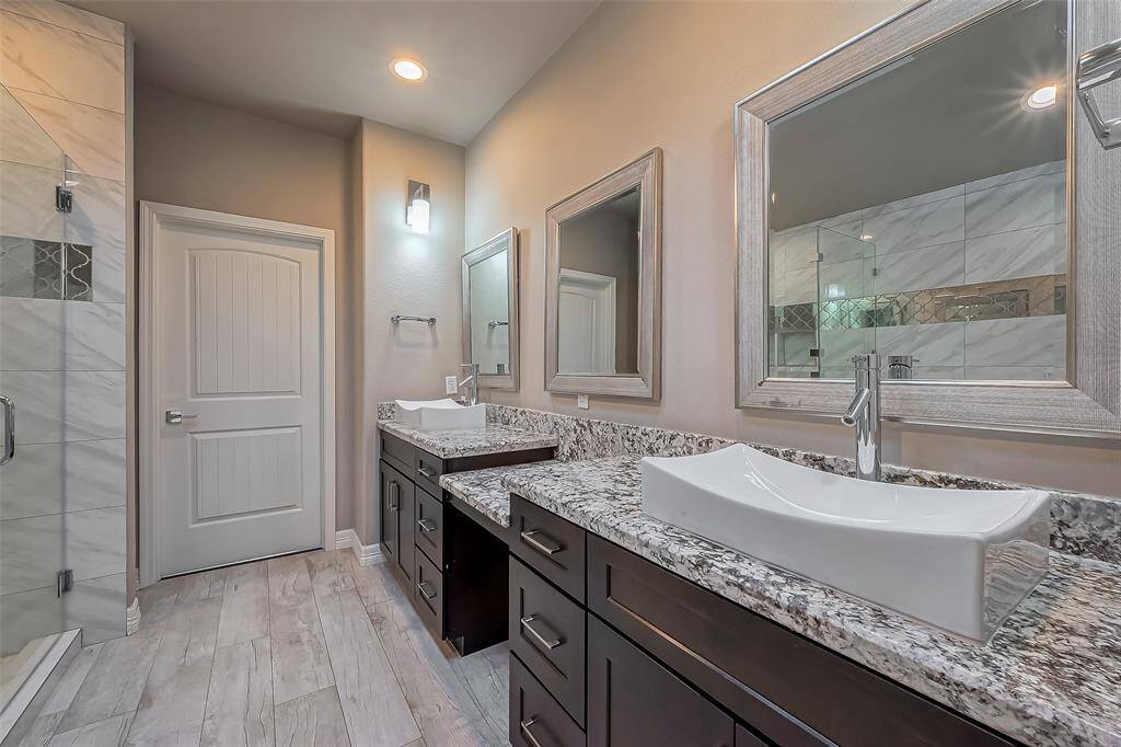 There are three large modern mirrors to accent the vessel sinks with space for two.