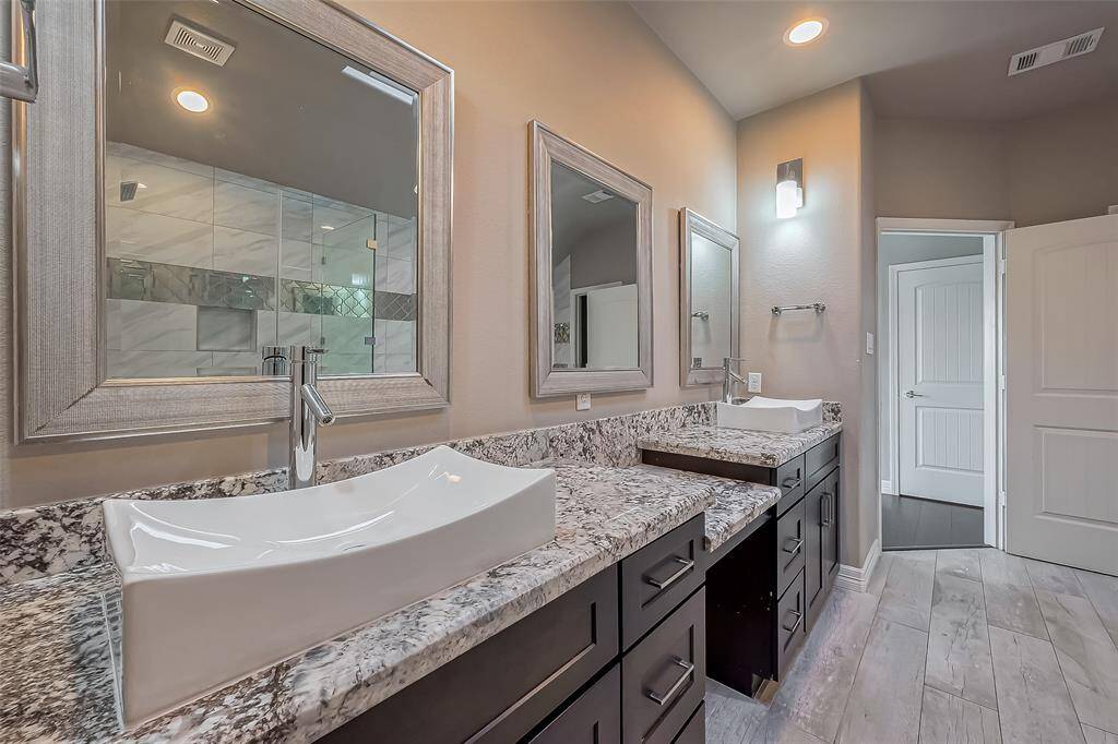 This ensuite primary bathroom has a skylight. This bathroom also has soft closing drawers and cabinets. There is also a makeup cutout to help when dressing in the morning and evening.