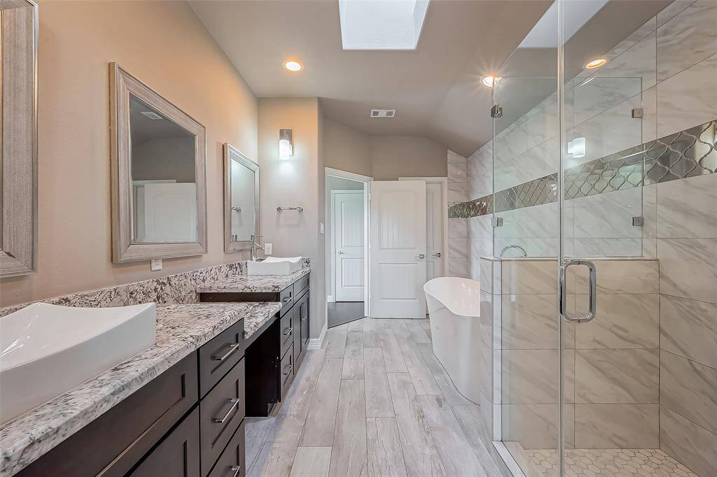 This primary bathroom is large and will definitely accommodate space for two.