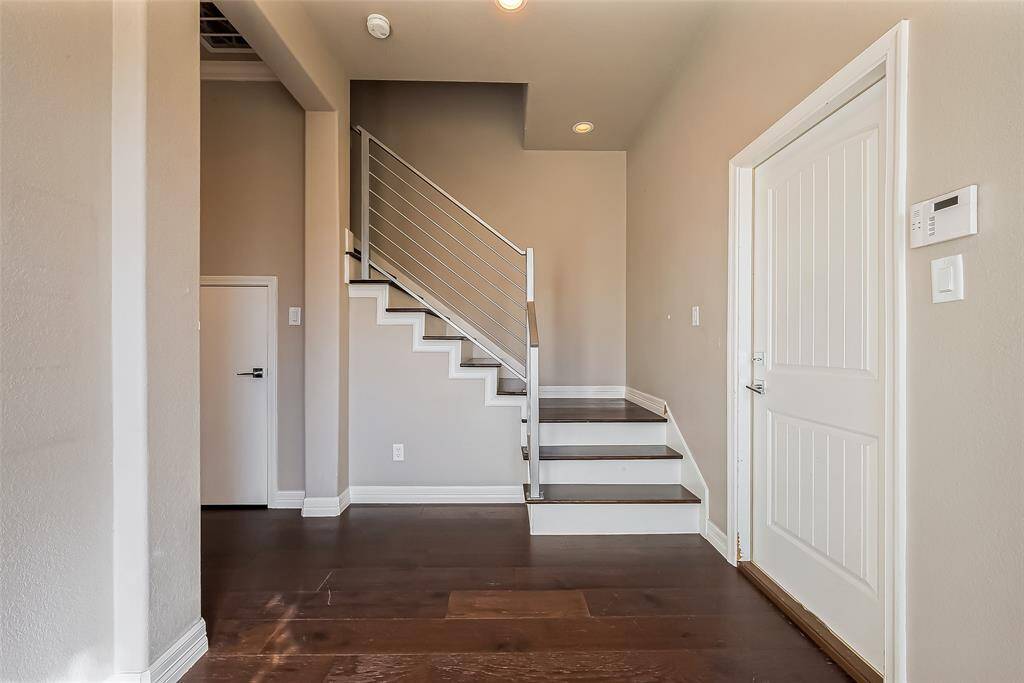 The stairwell railing is made of steel and laminate stairs for a modern look.