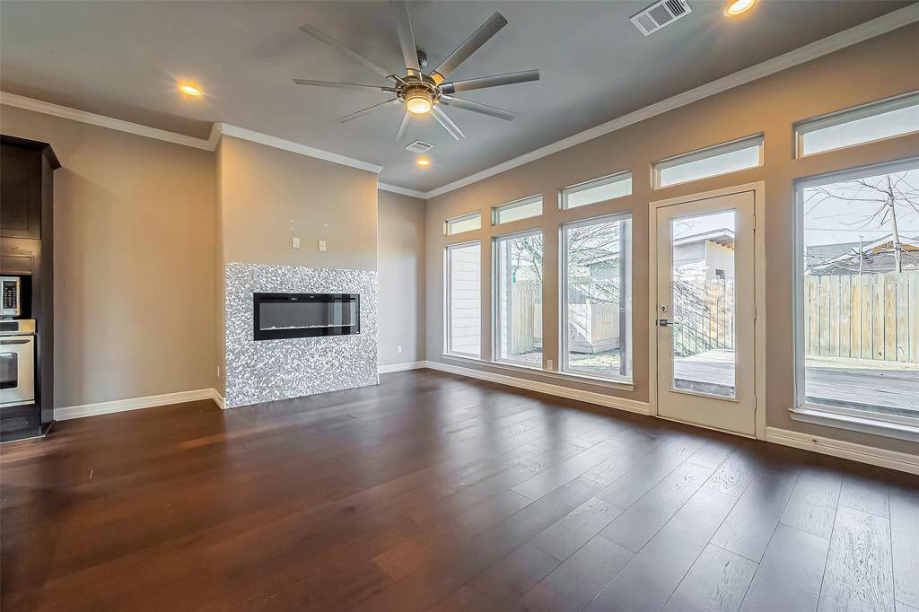 This living room has wall-to-wall windows that overlook the patio.