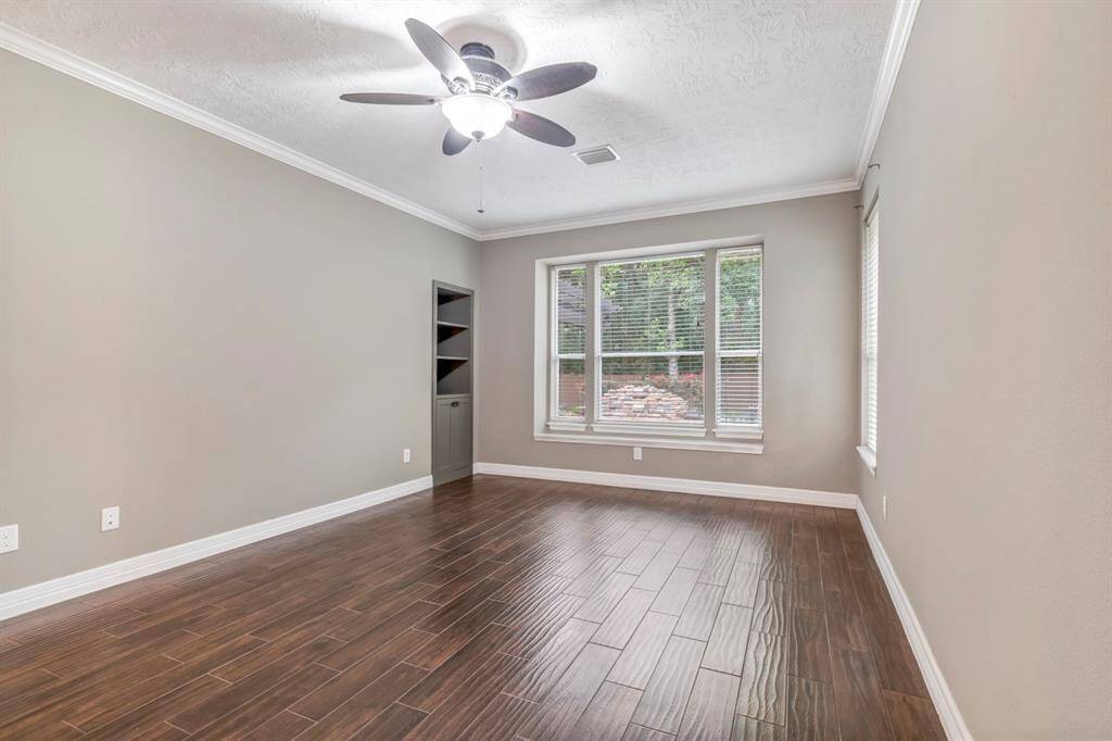 The primary bedroom has a custom built-in bookshelf for convenient storage.