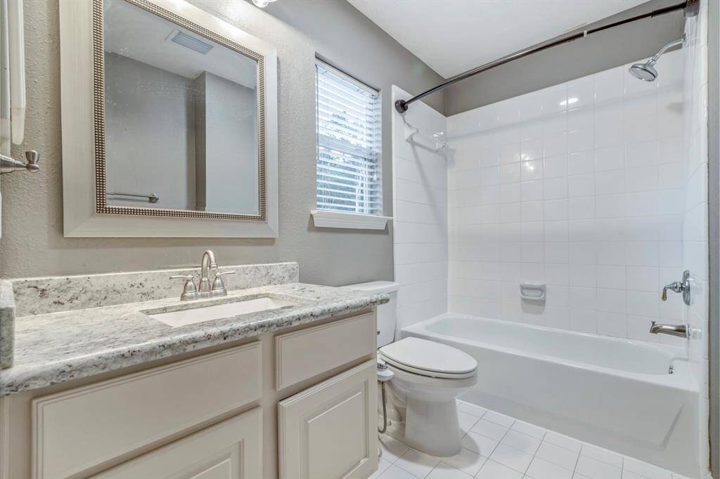 This full bathroom upstairs is detached from all bedrooms and easily accessible from the stairway.