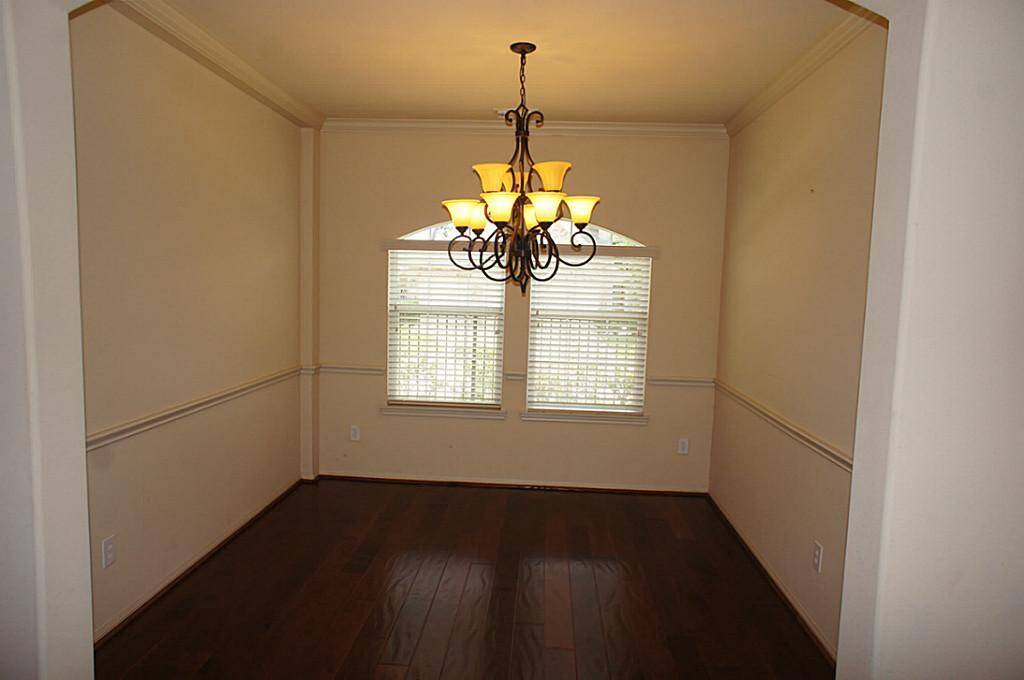 Formal Dining room offers beautiful wood floors, chair railing, and is conveniently located next to the kitchen.