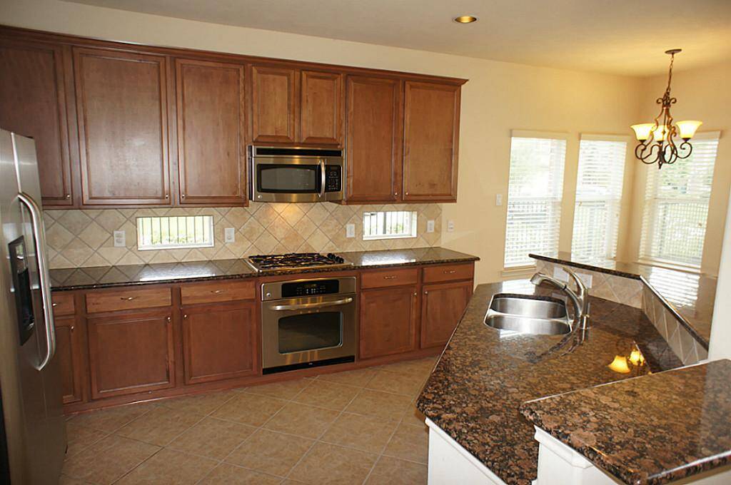 Spacious Kitchen with all stainless-steel appliances, sky light windows, granite countertops and abundant counterspace!