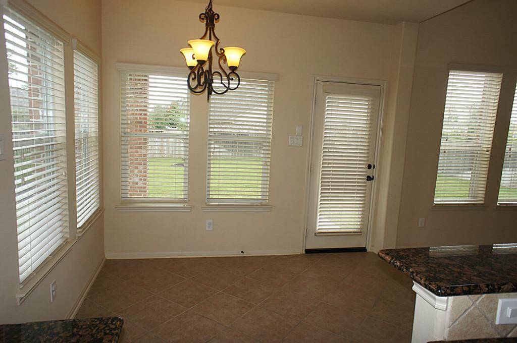 Breakfast area. Door leads to the Wrought Iron fully fenced backyard.