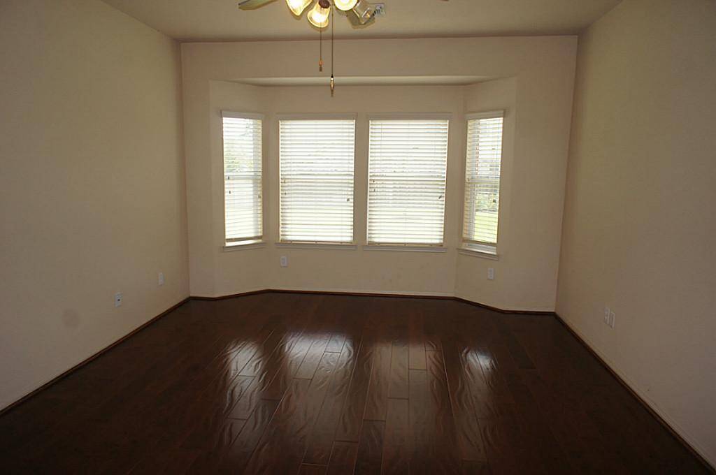 Spacious Master bedroom, located downstairs, has a great view of the backyard.