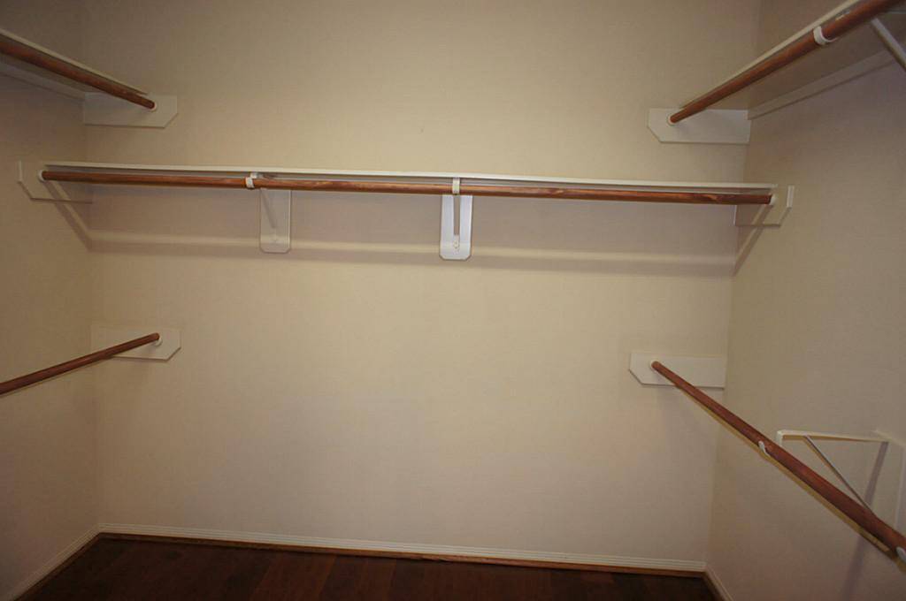 Master Walk-in Closet has beautiful wood floors.