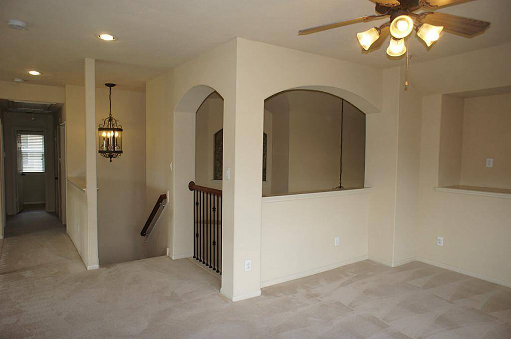Top of stairway, standing in the large gameroom.