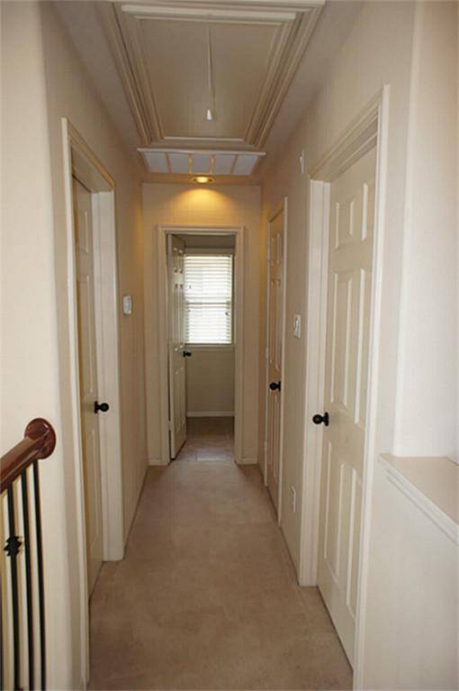 Lookiing down hallway across from the gameroom, towards secondary bedrooms and hall bathroom.