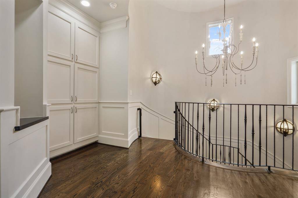 Elegant lighting enhances the room, complemented by generous storage solutions.
