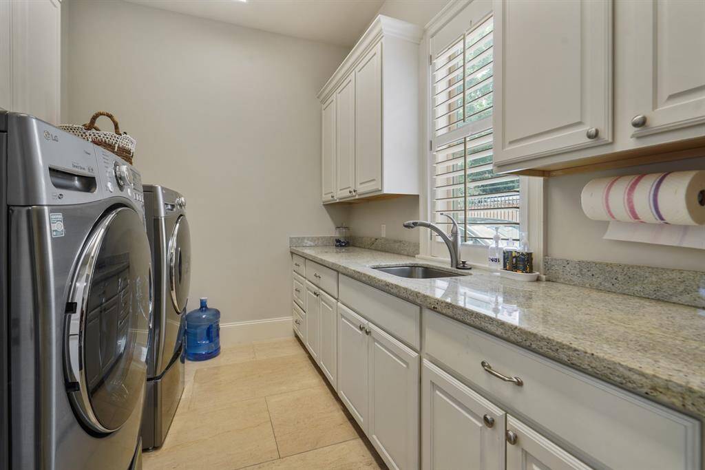 Spacious utility room featuring a convenient sink for added functionality.