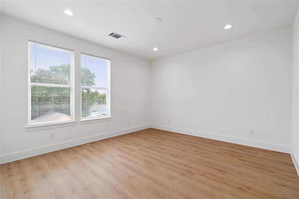 The spacious primary bedroom is filled with natural light, thanks to its large windows. It’s the perfect retreat, offering plenty of room to unwind and relax.
