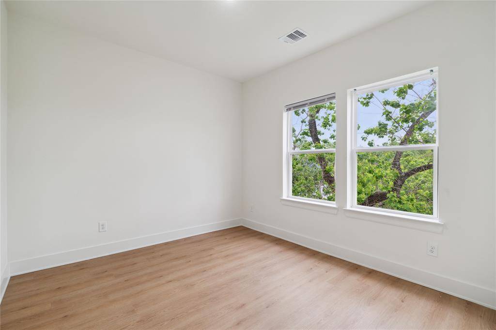 The home features durable and stylish LVP flooring throughout, including in the secondary bedrooms, offering a cohesive, modern look that’s both practical and easy to maintain