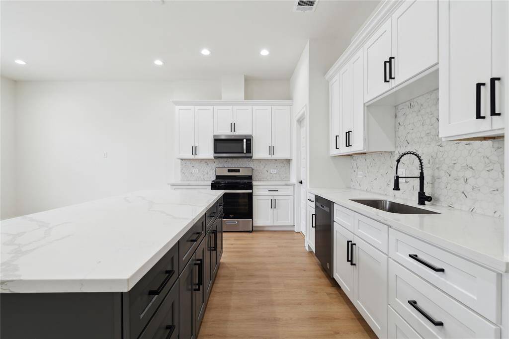 Designed with functionality in mind, the kitchen boasts an abundance of soft-close cabinets for all your storage needs. Sleek, quiet, and stylish—everything has its place.