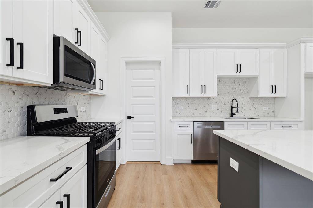 The kitchen comes equipped with sleek stainless steel appliances that blend style and performance. A modern touch that complements the clean, contemporary design