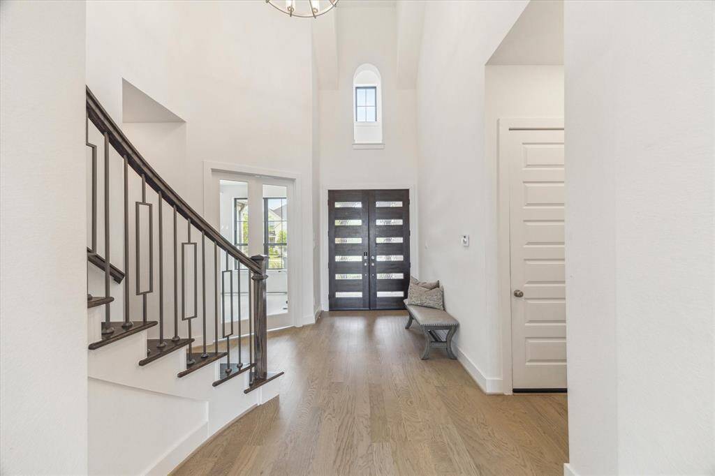 The soaring ceiling is the first thing you wil notice and then the beautiful neutral hardwood floors as you enter into this two story home through the double wood and glass doors.