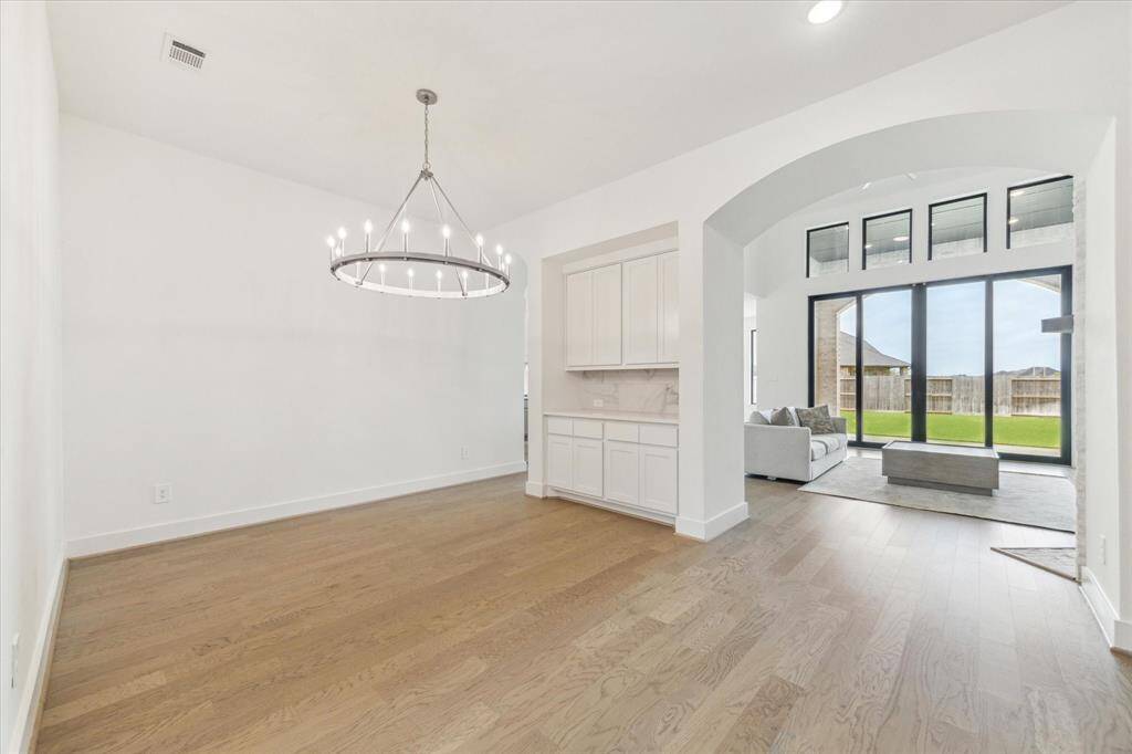 View of how open the formal Dining room is to the Kitchen and through the arches is the Family Room.