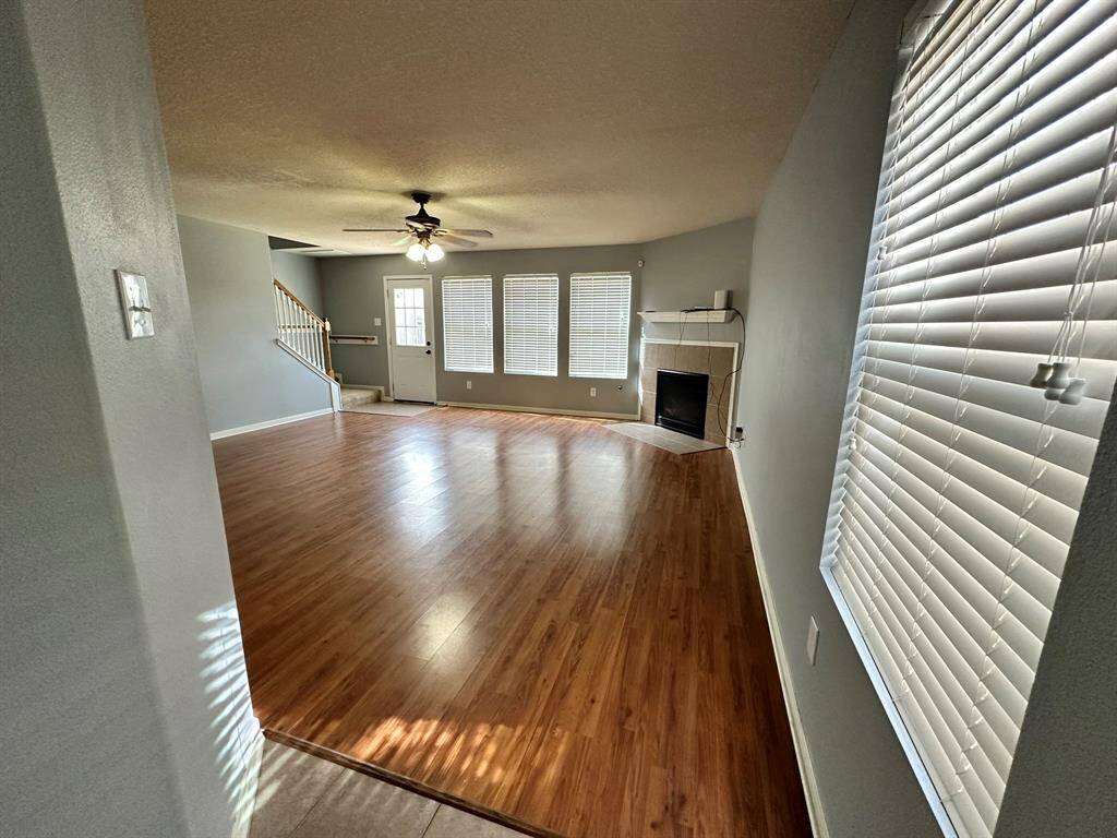 Enter into spacious living room with fireplace